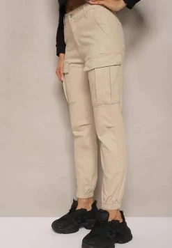 Beżowe Jeansy z Bawełny o Kroju Joggerów z Ozdobnymi Kieszeniami i Gumką w Pasie Unicella